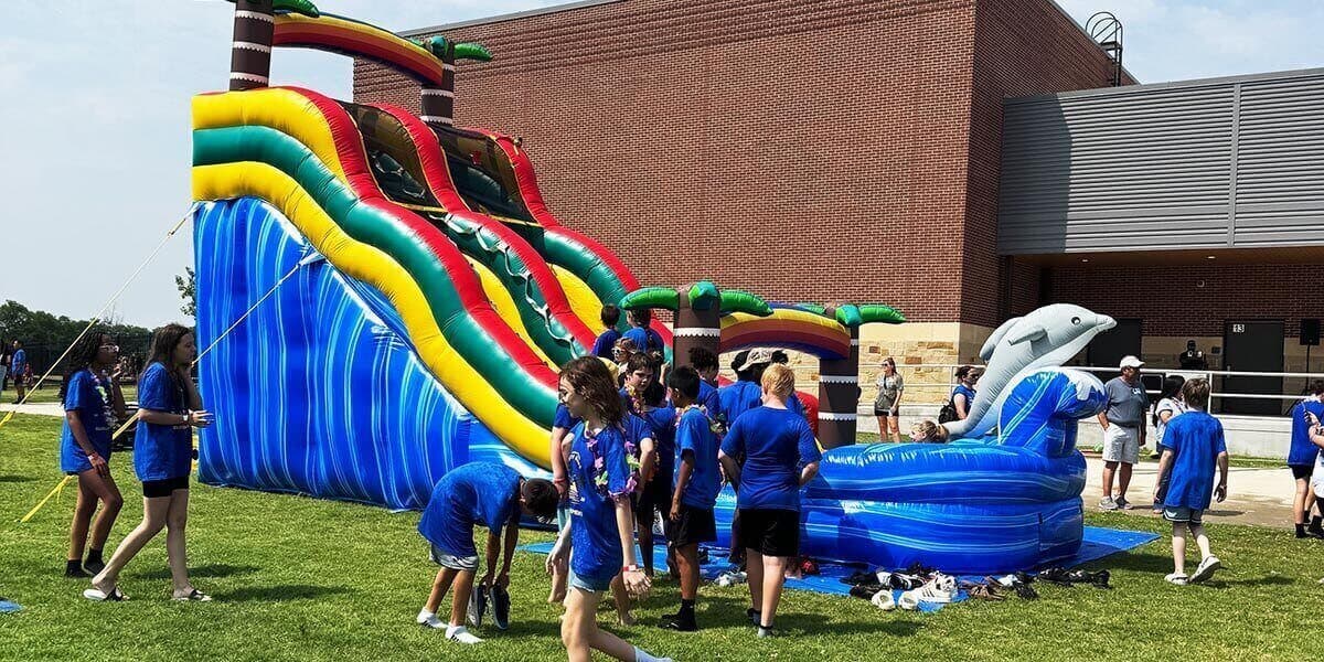 Kids having fun in bounce house and foam party combo rental experience